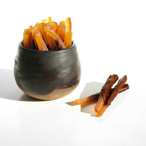 Orangettes, handcrafted chocolate-dipped candied orange peel with a perfect balance of bittersweet citrus and rich dark chocolate.