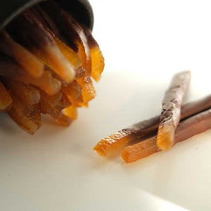 Orangettes, handcrafted chocolate-dipped candied orange peel with a perfect balance of bittersweet citrus and rich dark chocolate.
